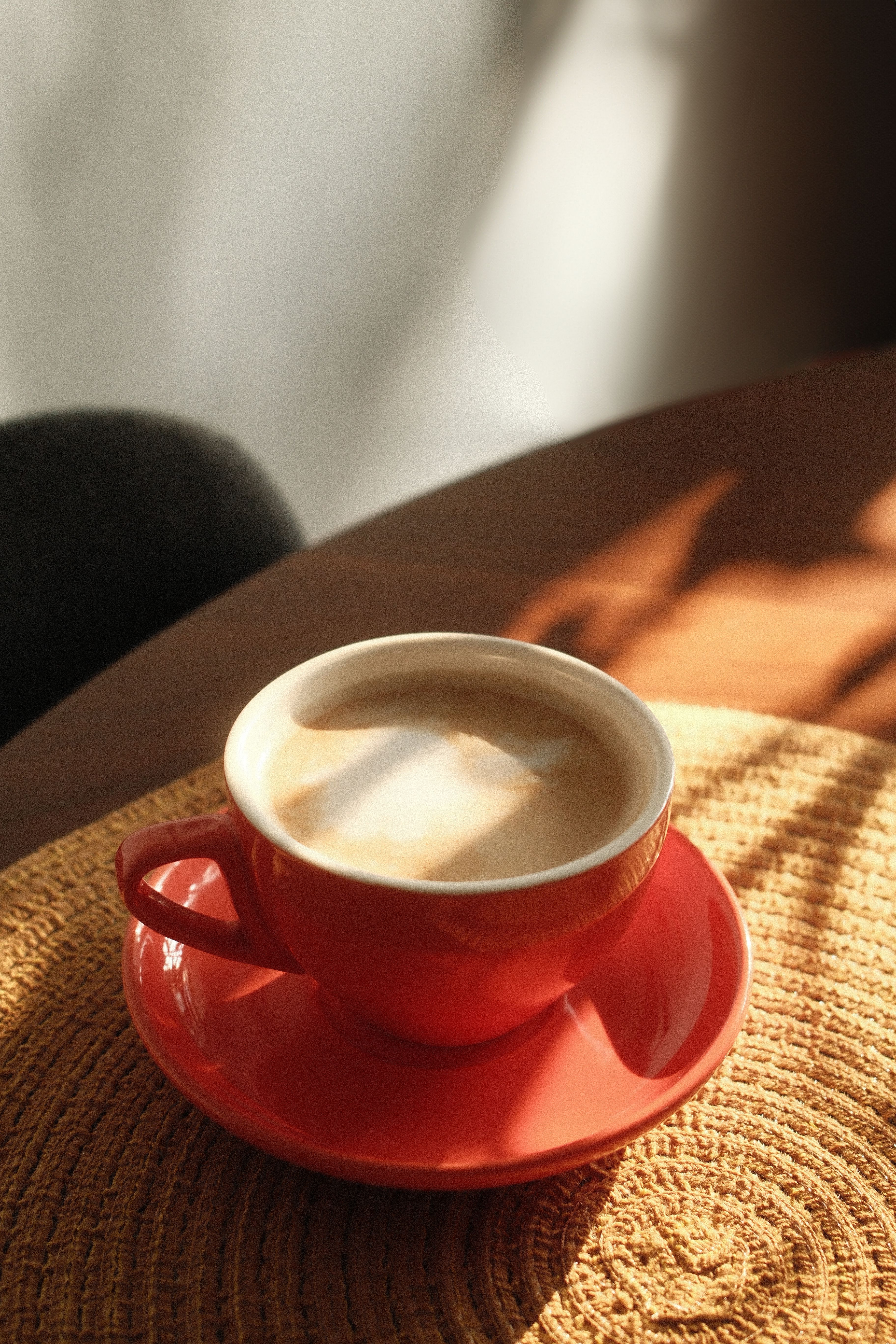 Warm morning light casts shadows over a coffee cup in a Montreal cafe.