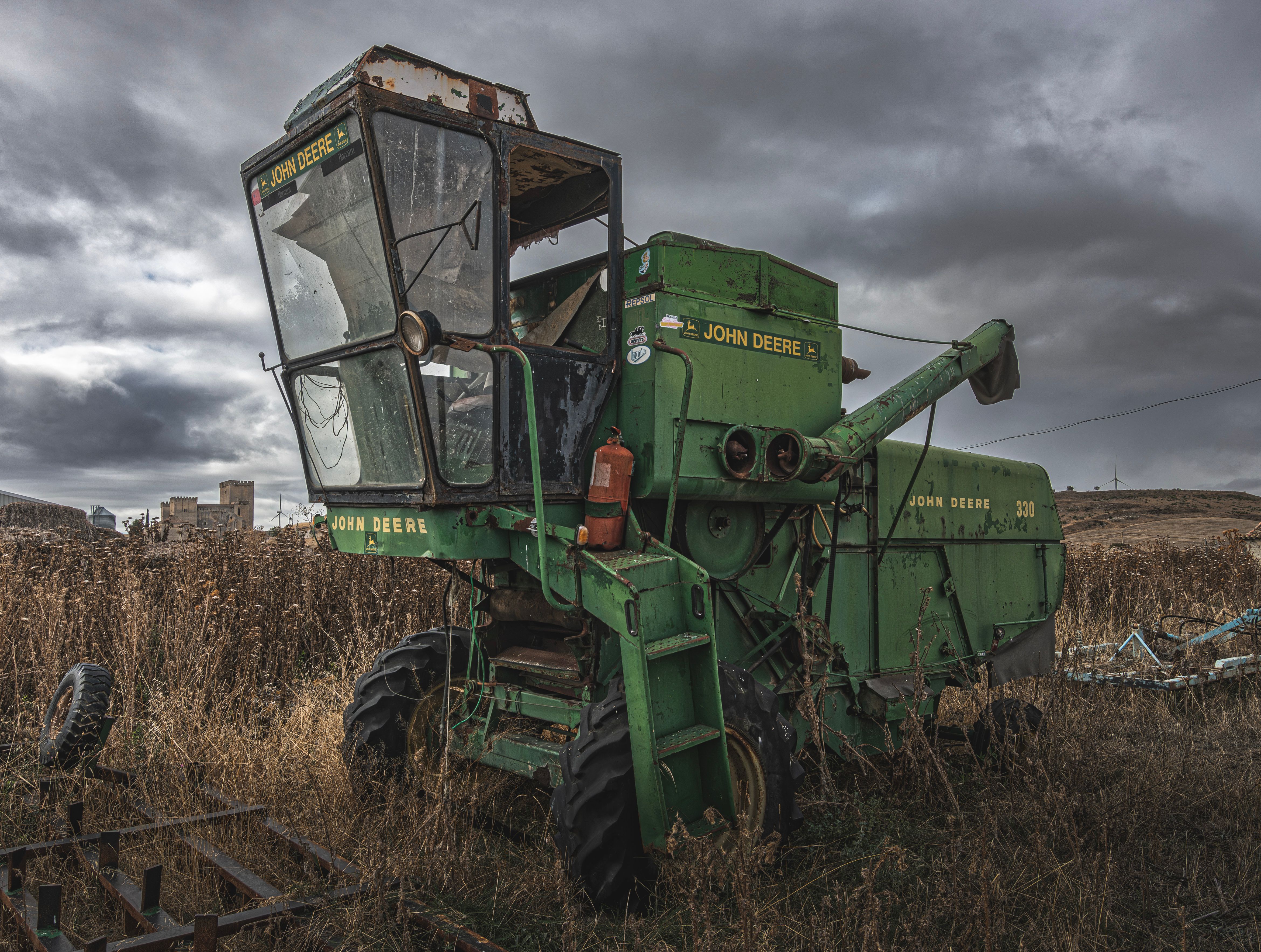 Old combine harvester sitting in an Arkansas fence row waiting to be hauled off
