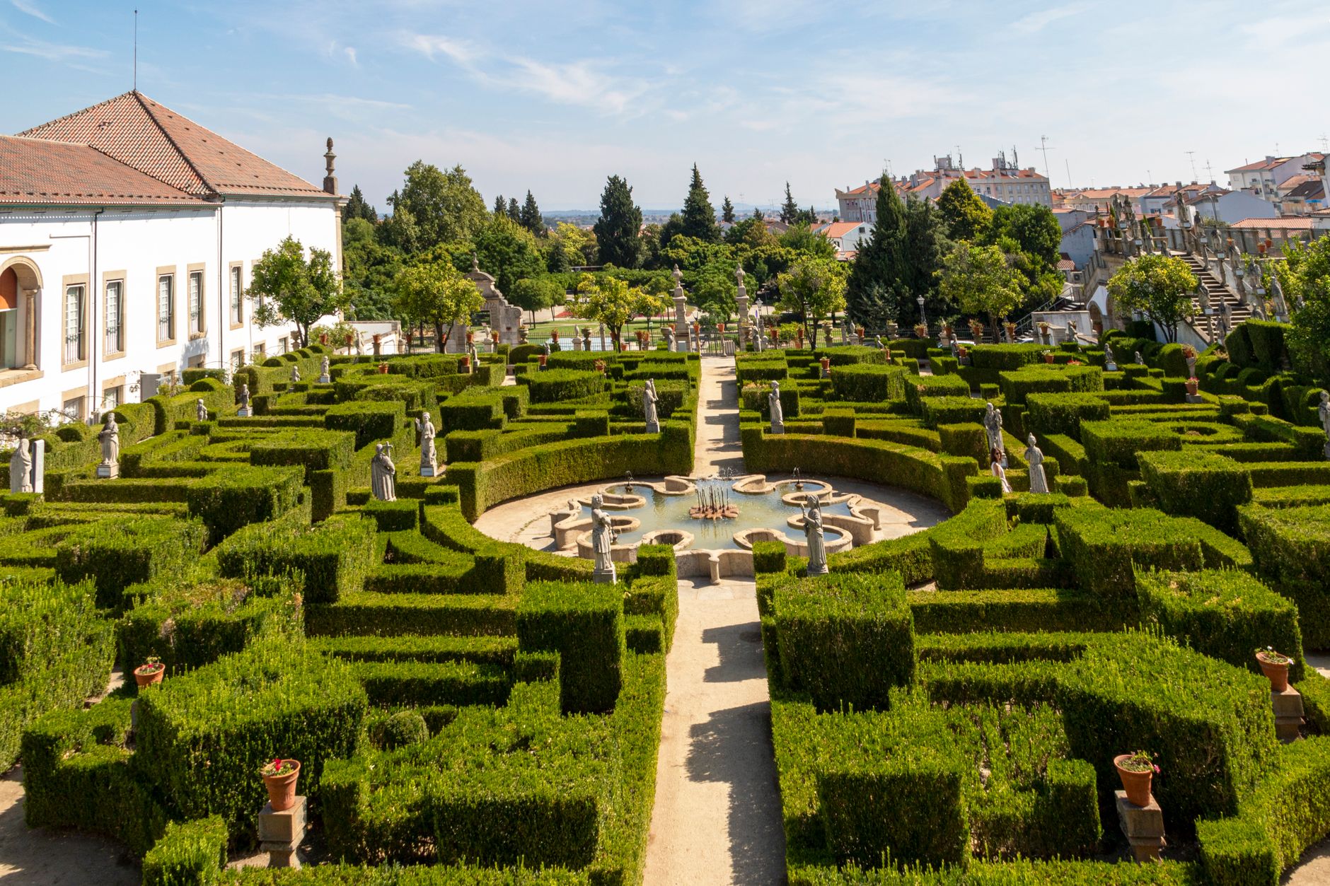 Aerial view of the intricately designed garden maze at Castelo Branco with statues and a fountain.