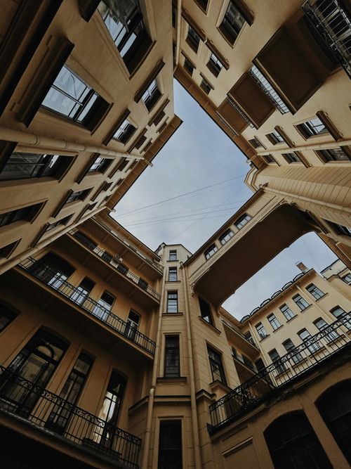 Free Upward view of classic Saint Petersburg architecture with enclosed courtyard structure. Stock Photo