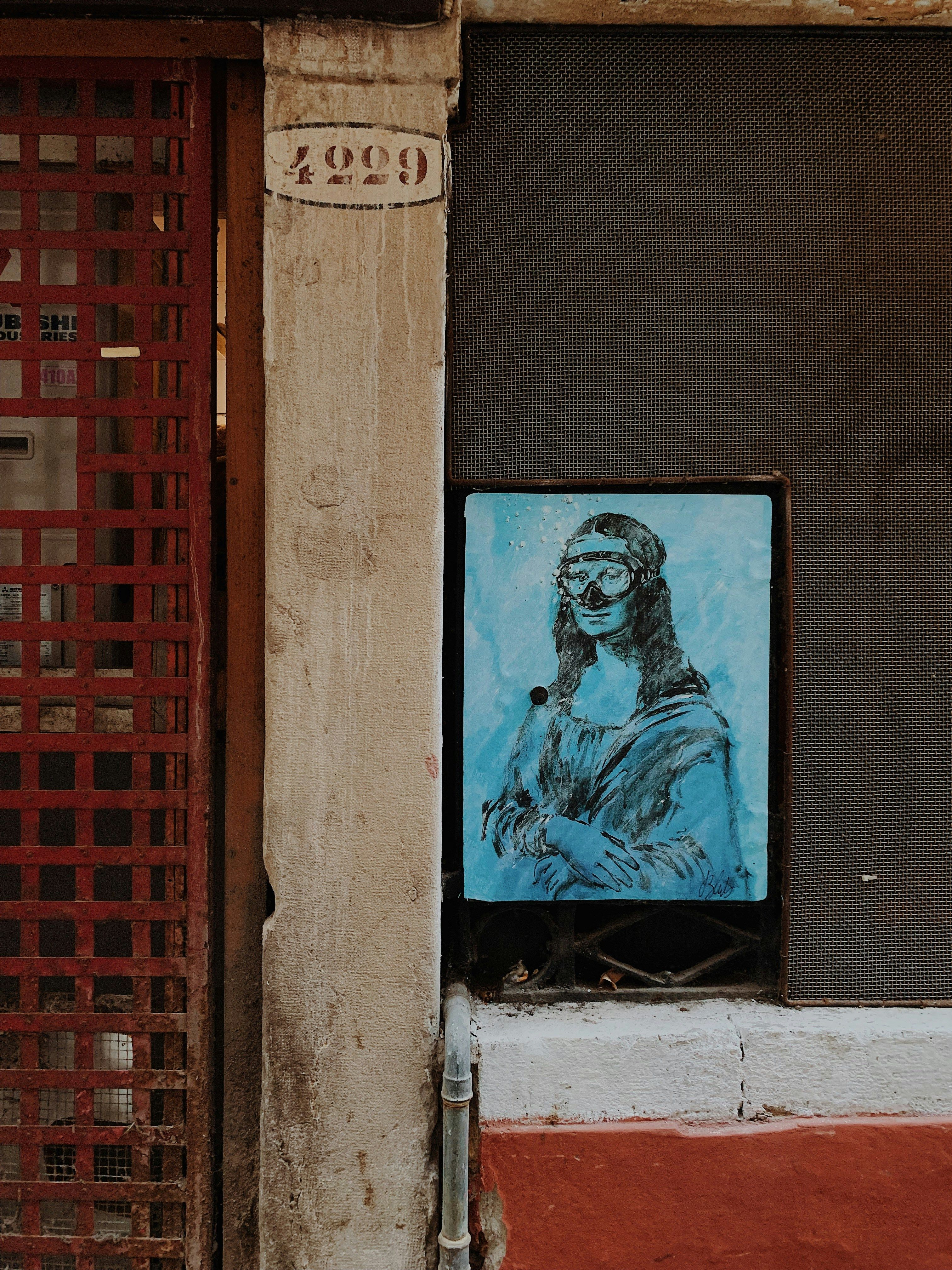 Street art depiction of Mona Lisa on a rustic wall in Venice, Italy.