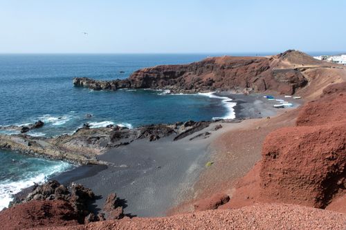 Free Stunning black sand beach and volcanic cliffs at El Golfo, Lanzarote, Spain. Stock Photo
