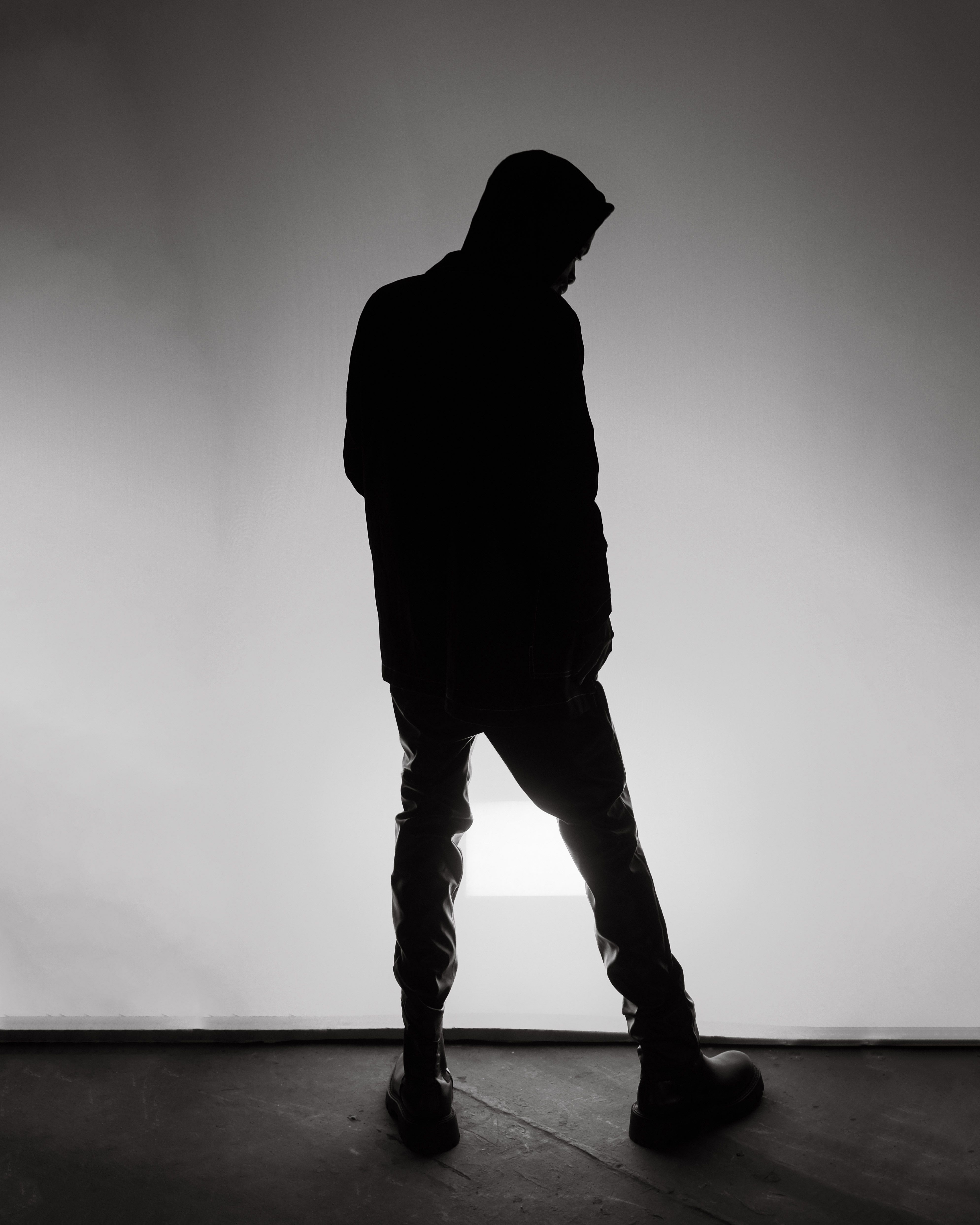 Dramatic Silhouette of Person in Shadowy Room · Free Stock Photo