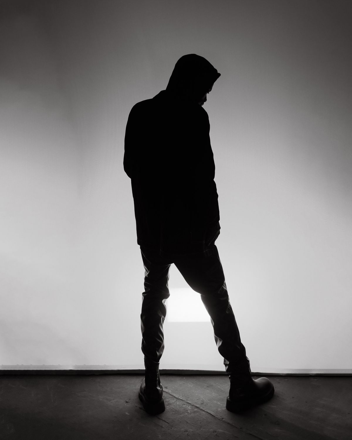Dramatic Silhouette of Person in Shadowy Room · Free Stock Photo