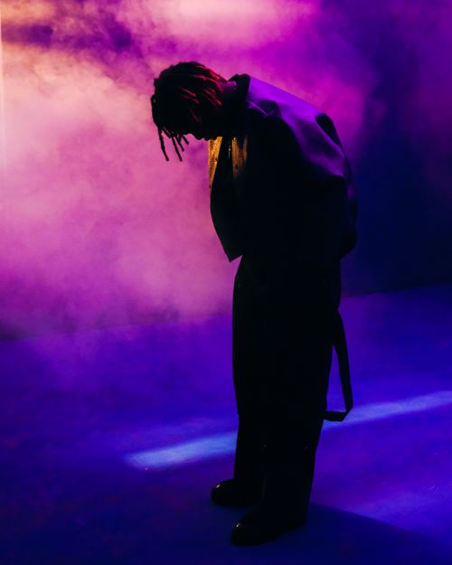 Free Silhouette of a person surrounded by vibrant pink and purple smoke. Stock Photo
