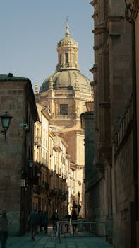 Street view leading to the grand dome of Salamanca Cathedral in Spain.