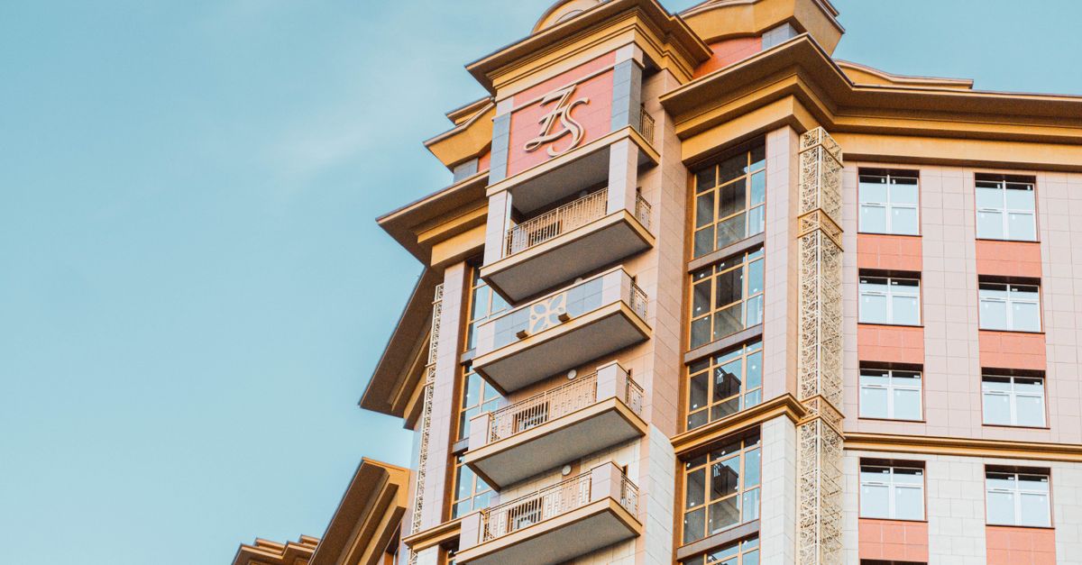 Elegant high-rise building facade in Moscow showcasing modern architecture under a clear sky.