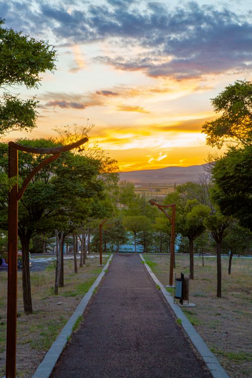 Scenic Park Pathway at Sunset with Vibrant Sky · Free Stock Photo