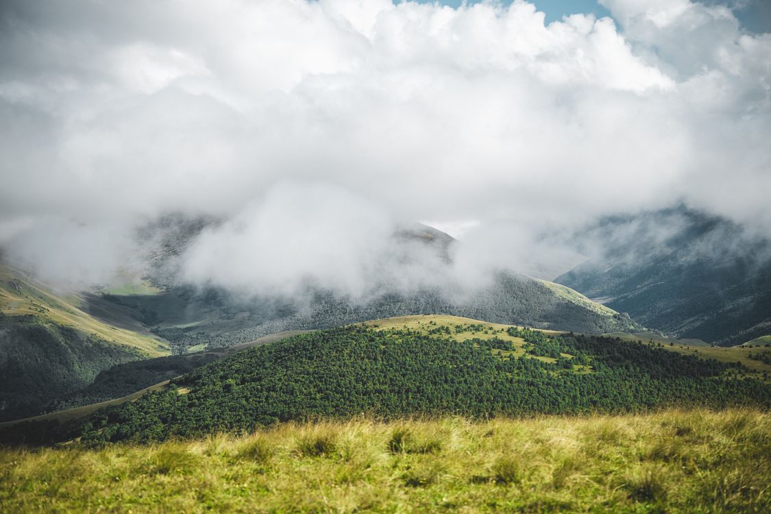 Majestic Mountain Landscape with Rolling Clouds · Free Stock Photo