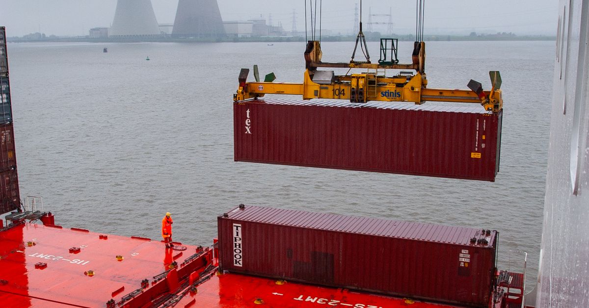 Loading Containers Near Industrial Towers · Free Stock Photo