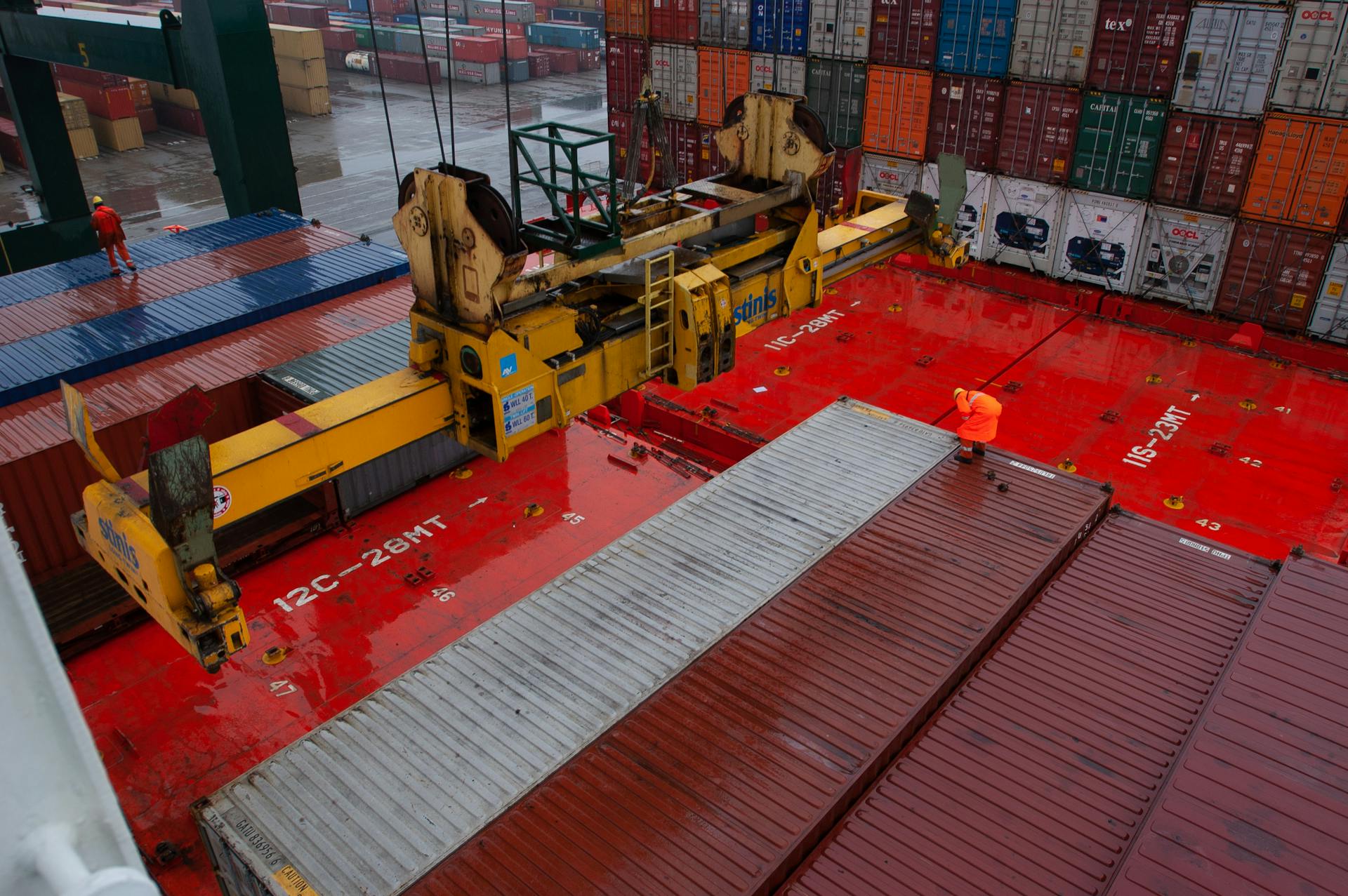 Container port with gantry crane loading cargo, capturing maritime logistics.