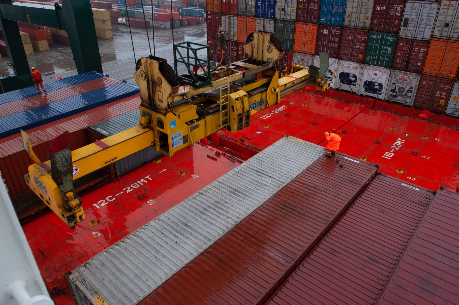 Worker on Duty: Checking the Container Loading · Free Stock Photo