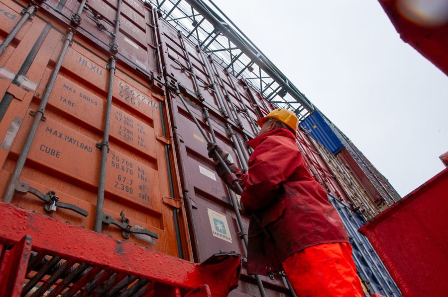 Workers securing cargo containers