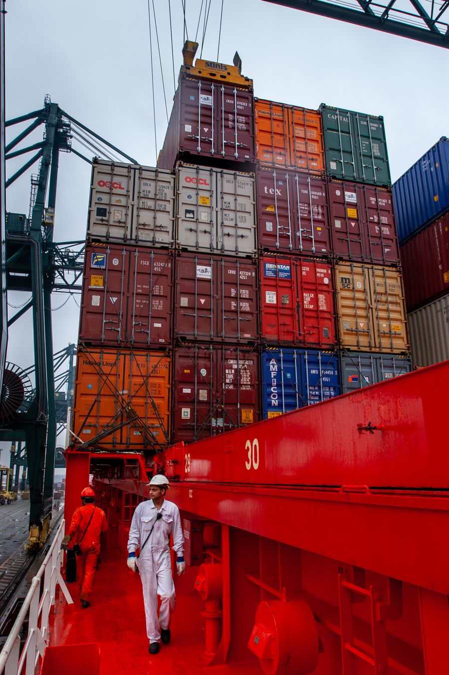 Maritime workers on a container ship deck