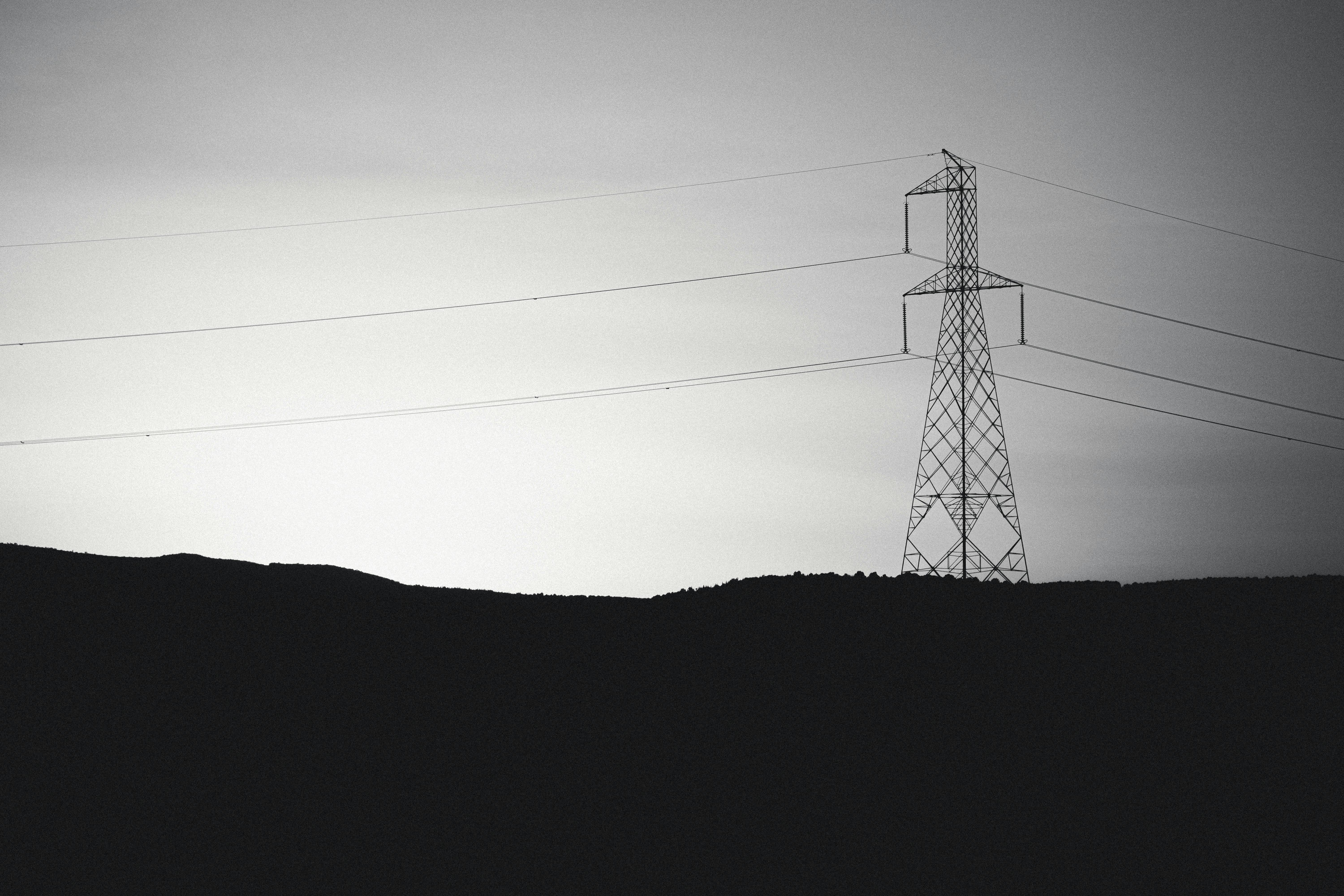 A serene view of a transmission tower set against a twilight sky in Jendouba, Tunisia.