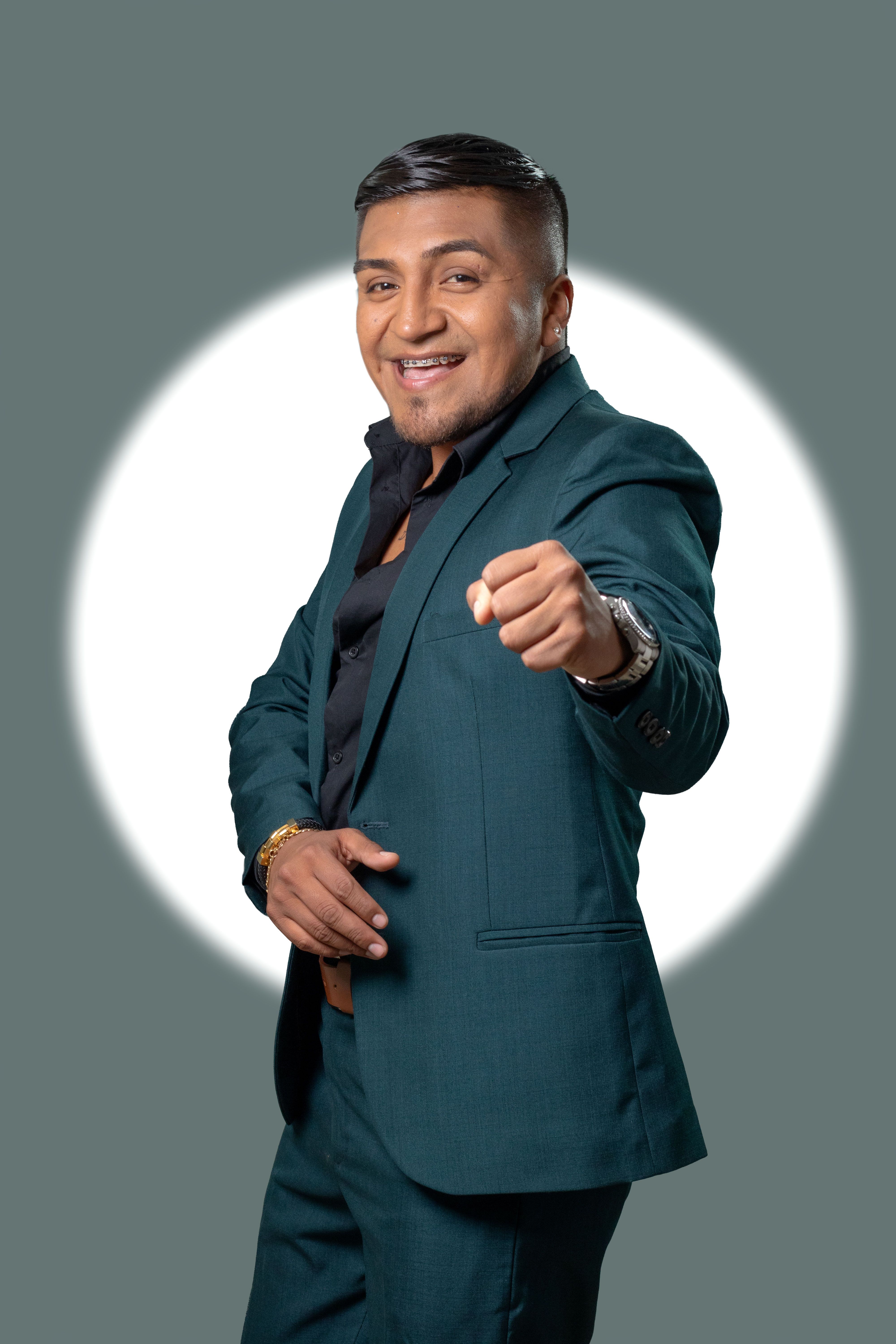 Confident man in formal suit posing with a cheerful expression.