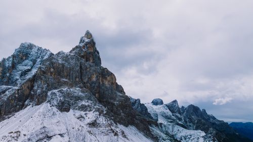 Free Snowy mountains under cloudy skies in the Dolomites, Italy. Stock Photo
