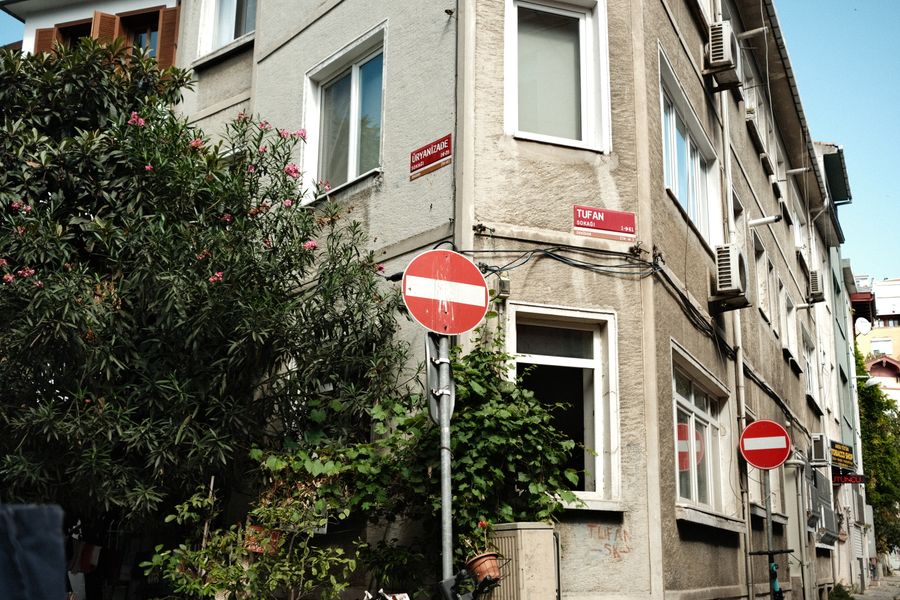 A city street corner with signs and buildings