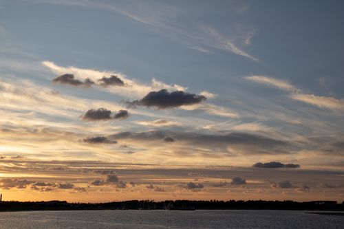 Free Peaceful sunset over North Sea with clouds and horizon view in Amrum, Germany. Stock Photo