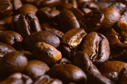 Free Detailed close-up of roasted coffee beans showcasing texture and color. Stock Photo
