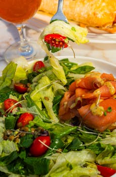 Delicious smoked salmon with a crisp salad of lettuce, cherry tomatoes, and seeds.
