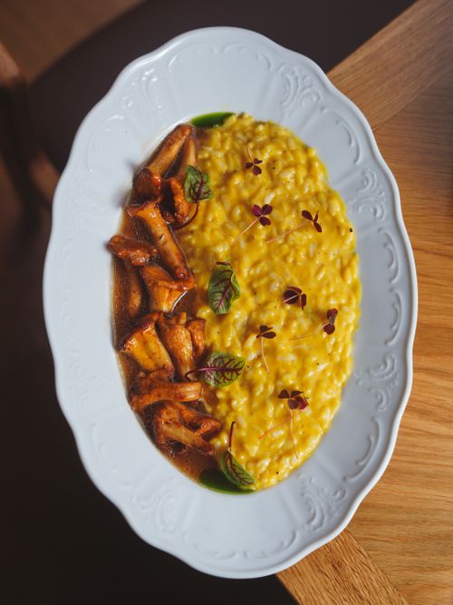 Free Delicious saffron risotto with mushrooms served on a fine white porcelain plate. Stock Photo