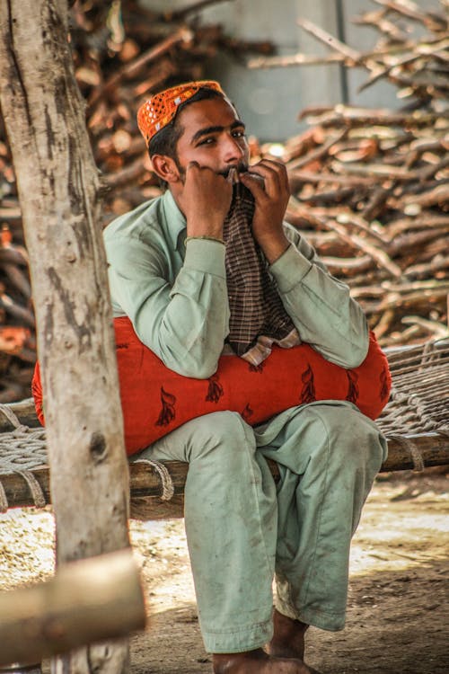 Man Sitting On A Hammock 