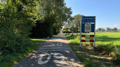 Free A calm rural road leading into Bathmen, Netherlands with clear summer skies. Stock Photo
