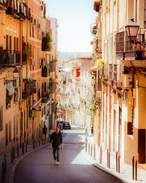 Free Picturesque view of a sunlit street in Madrid, capturing the essence of the city's vibrant architecture. Stock Photo