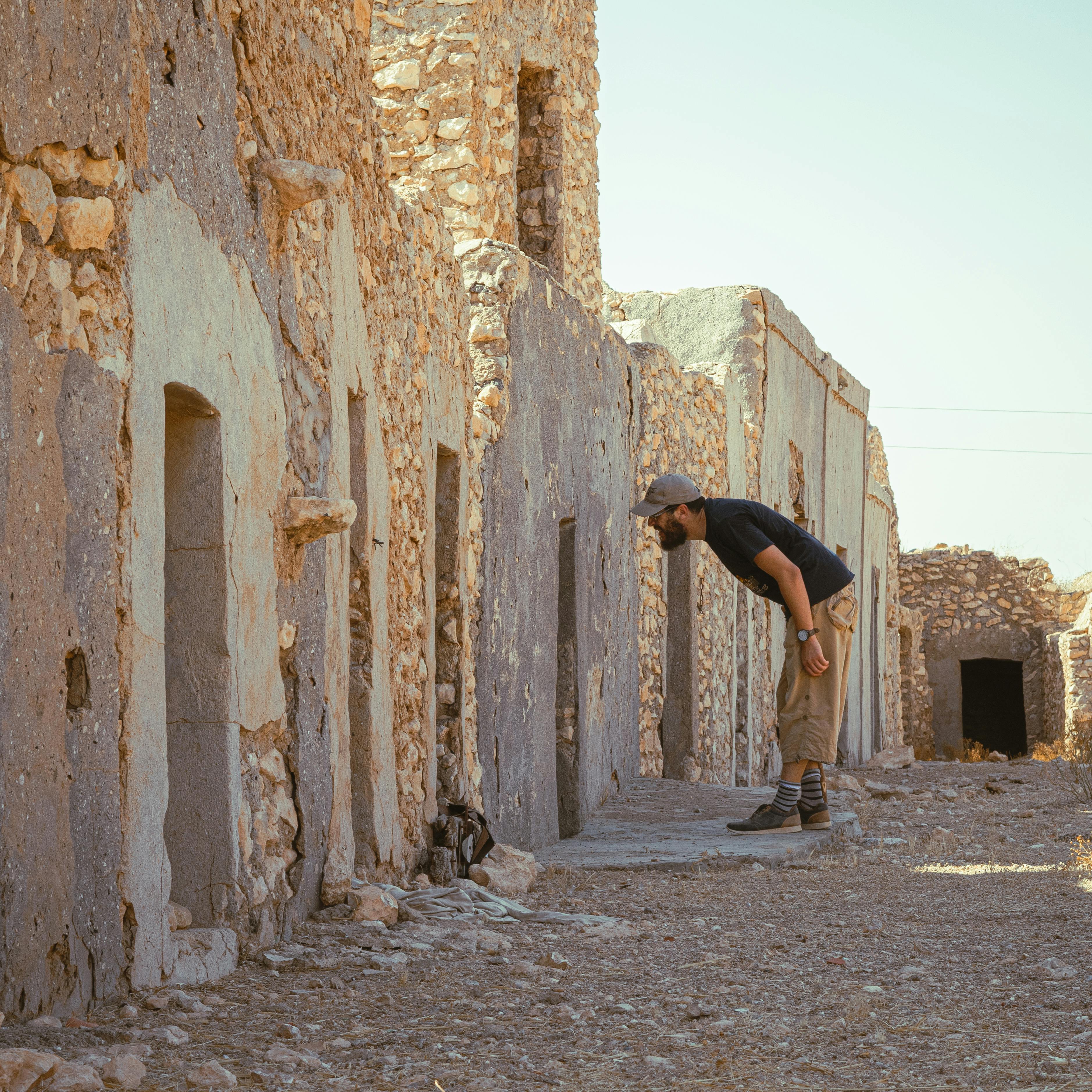 Man exploring ancient stone architecture in Tataouine, Tunisia.
