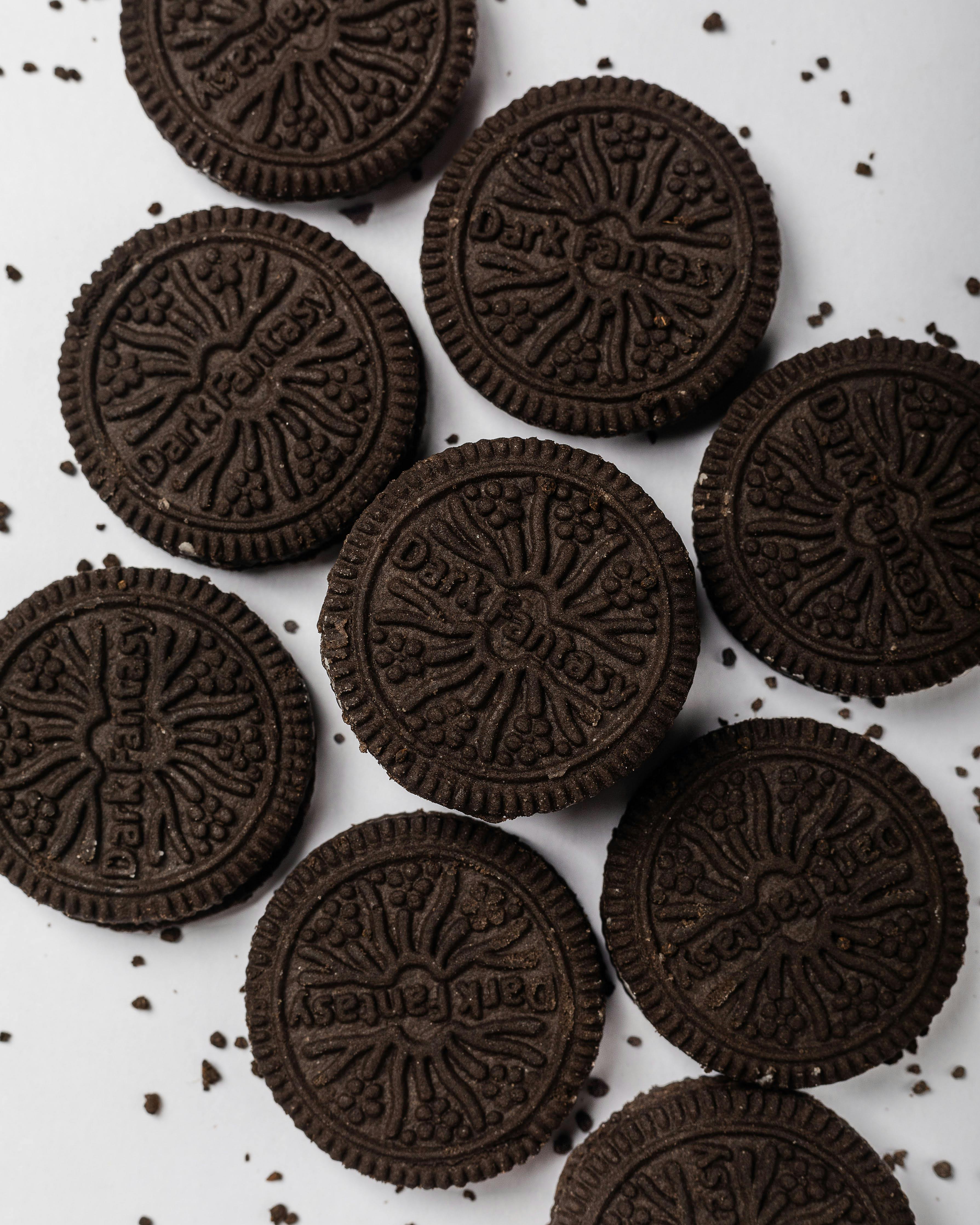Delicious chocolate sandwich cookies with cream on a white background, perfect for food blogs.