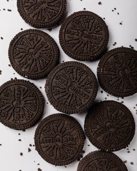 Delicious chocolate sandwich cookies with cream on a white background, perfect for food blogs.