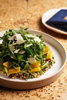 Delicious arugula salad with citrus, parmesan, and grains on a stylish plate.