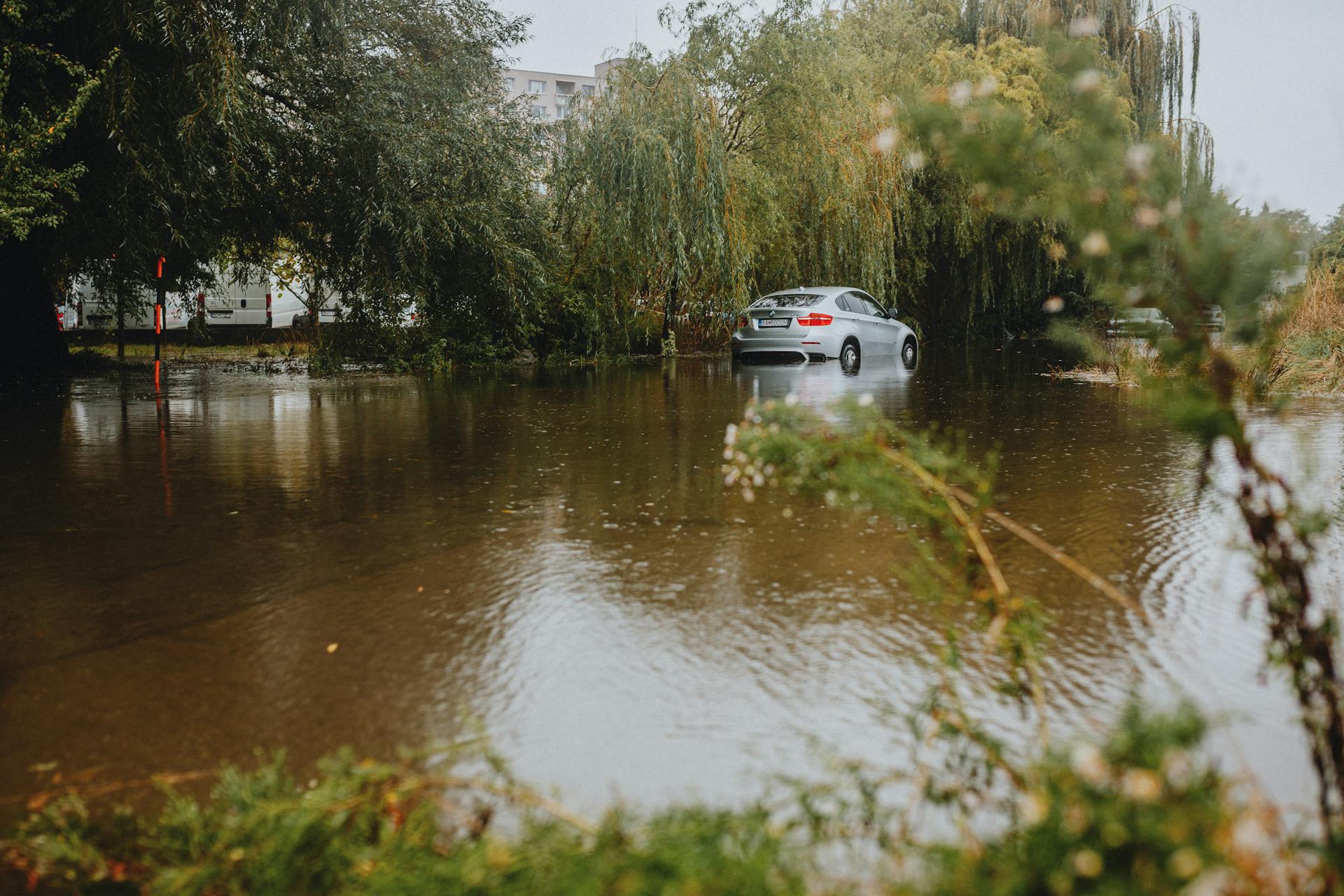 Car Partially Submerged in Flooded Area