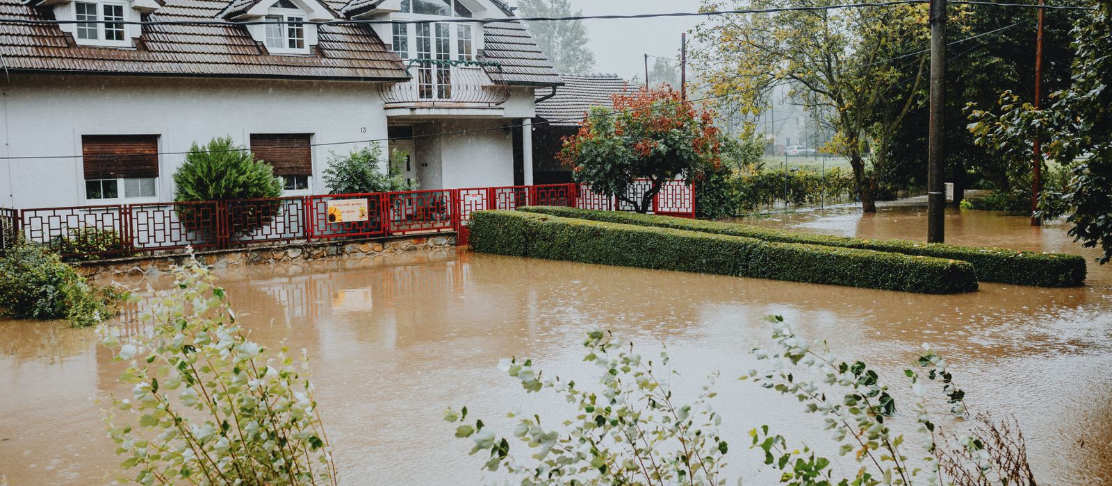 Suburban house surrounded by floodwater after heavy rain