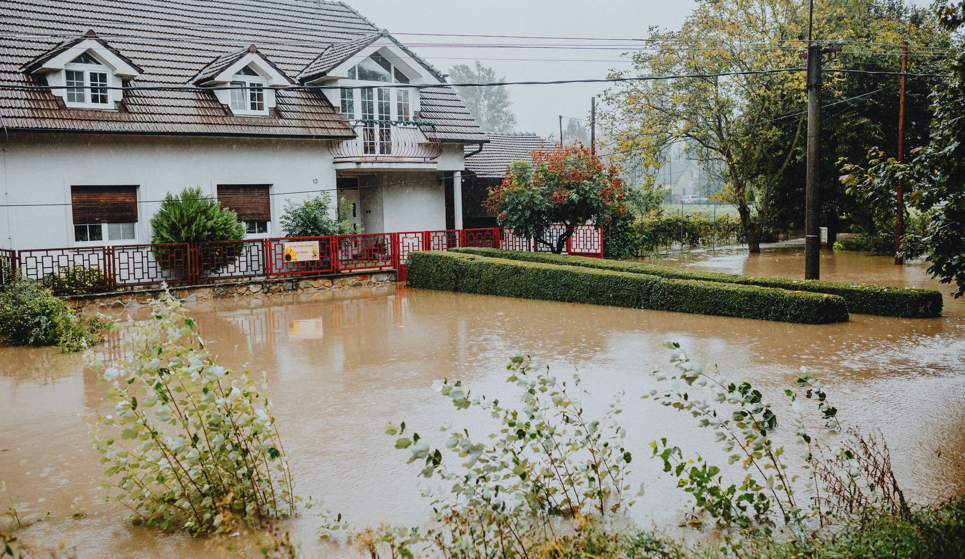 Suburban house surrounded by floodwater after heavy rain