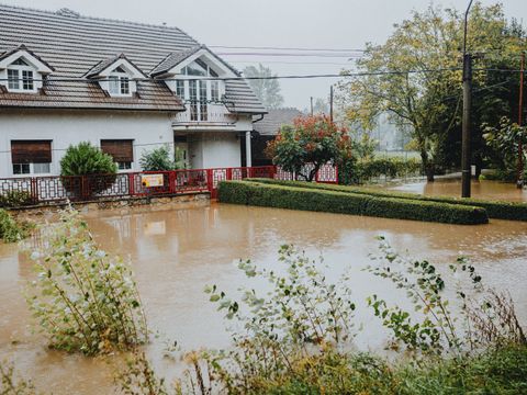 Suburban house surrounded by floodwater after heavy rain