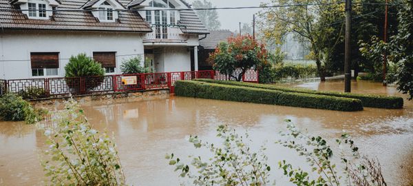 Suburban house surrounded by floodwaters after heavy rain