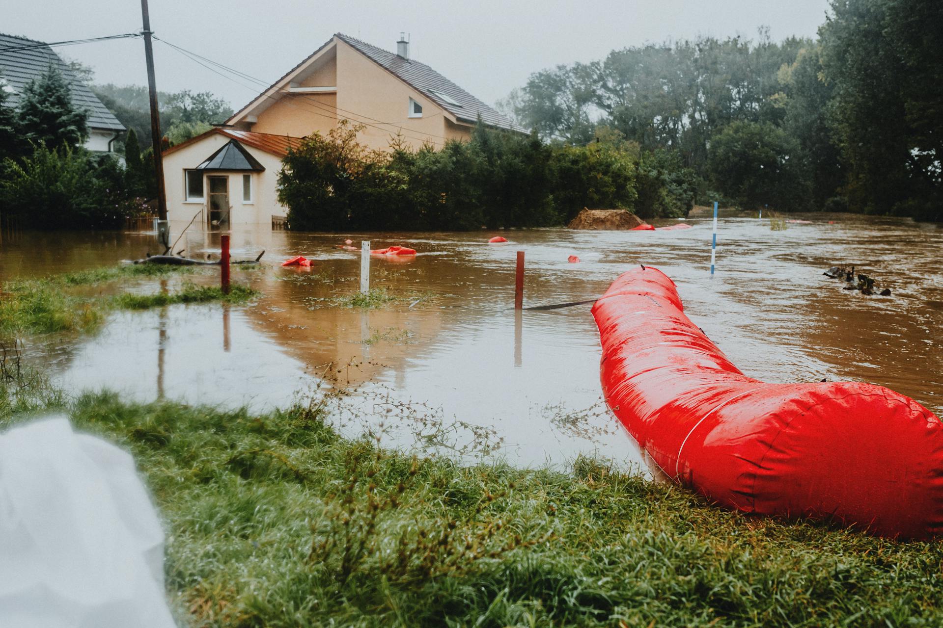 Flooded Residential Area with Red Barrier