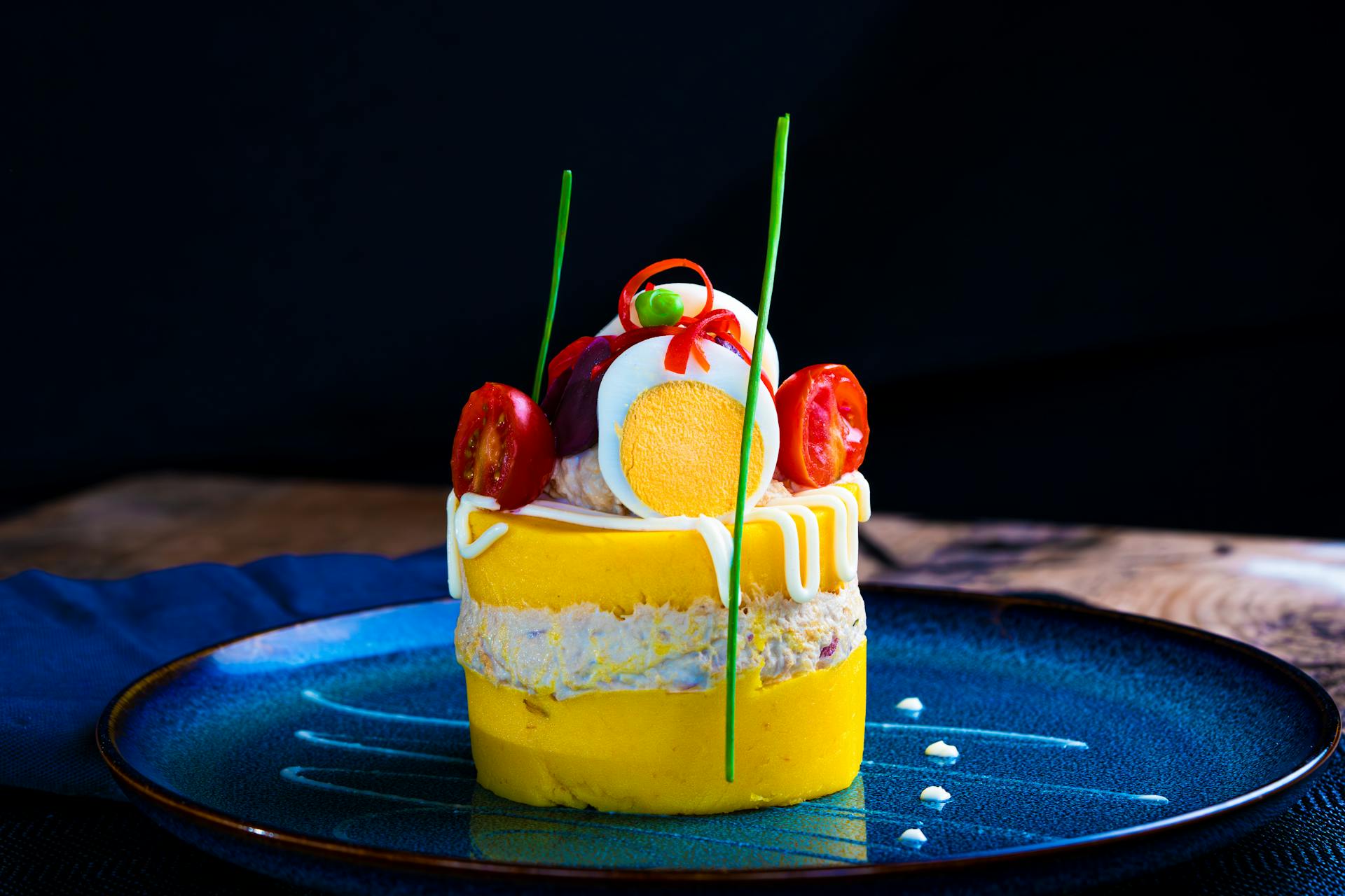 Elegant Peruvian Causa Rellena on Blue Plate