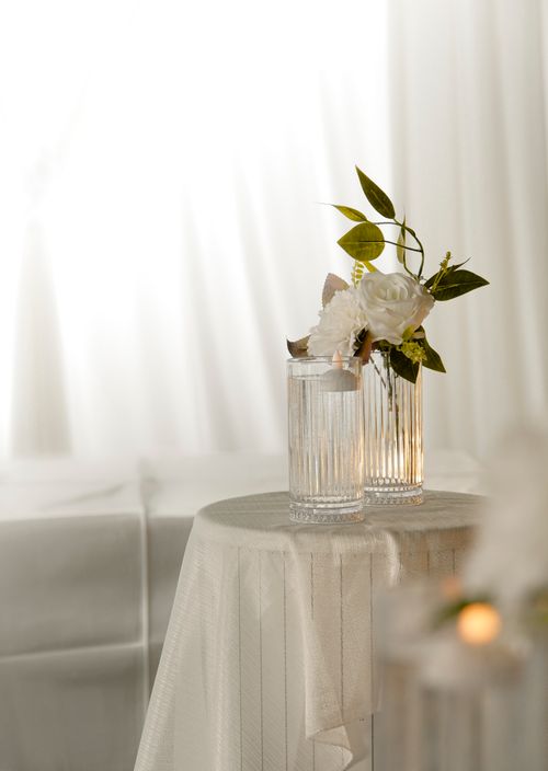Free Sophisticated table setup with a floral arrangement in elegant glass vases, perfect for weddings or events. Stock Photo