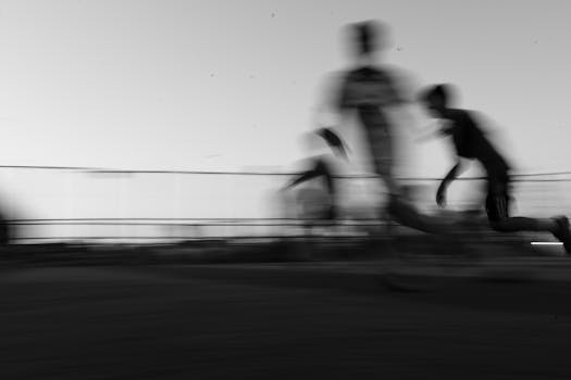 Dynamic black and white photo of runners in motion, conveying speed and movement.