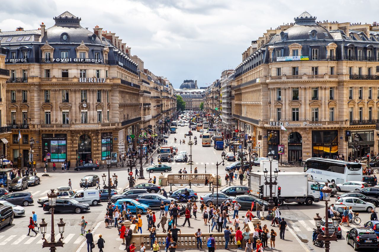 vibrant street view of central paris filled with people and traffic on