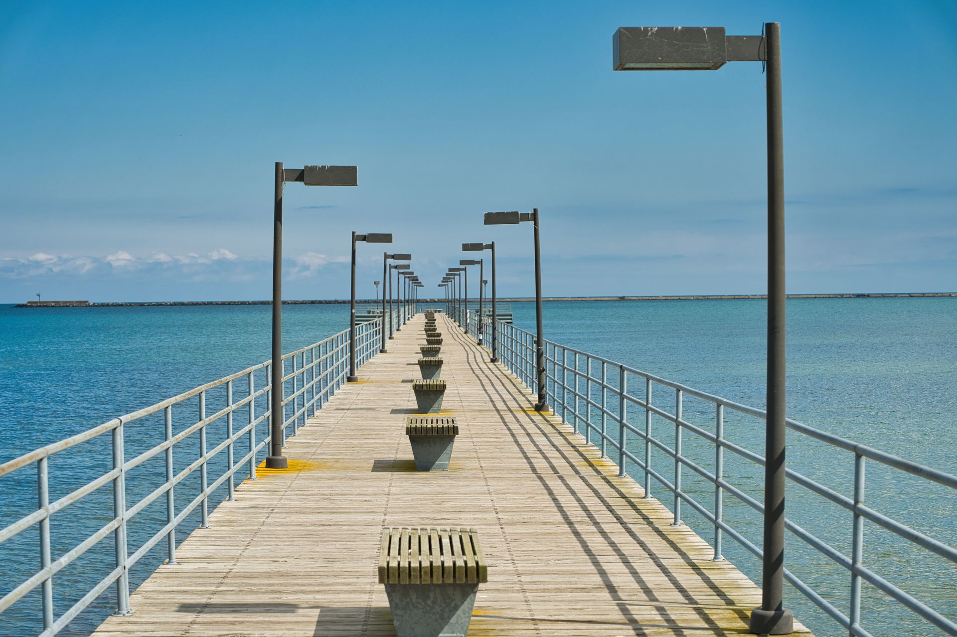 A serene view of the pier extending into Lake Huron at Harbor Beach, Michigan.
