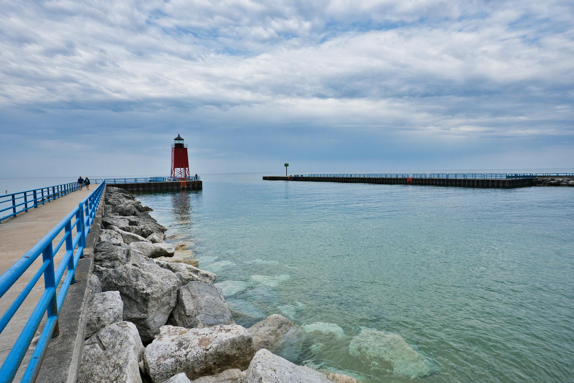 Beautiful view of Charlevoix South Pier Lighthouse with tranquil Lake Michigan waters.