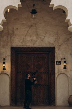 A videographer capturing historic architecture in Shindagha, Dubai.