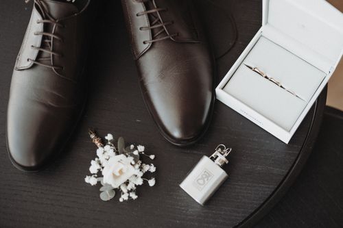 Free Stylish wedding accessories including shoes, boutonniere, and cufflinks on display. Stock Photo