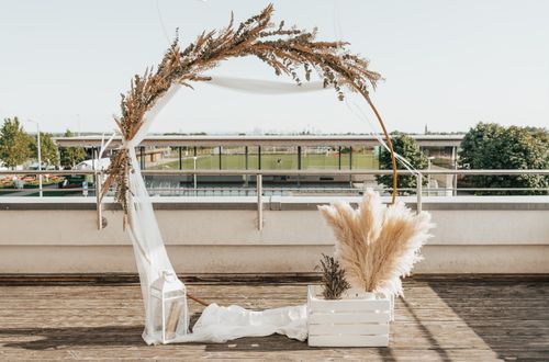 Free Beautifully styled wedding arch with pampas grass and lantern outdoors. Stock Photo