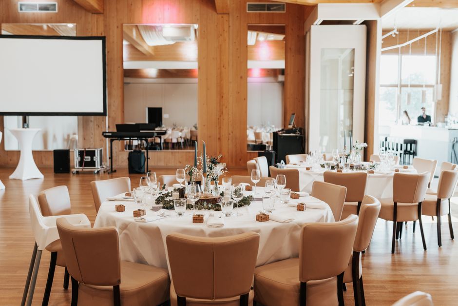 Round tables set for a wedding reception in Southern Utah with elegant place settings and linens
