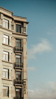Side view of a historic hotel building with classic architecture against a clear sky.